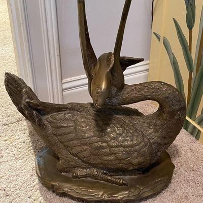 brass pelican with fish in mouth