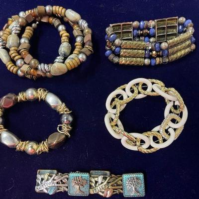 assortment of beaded bracelets and tree of life bracelet 