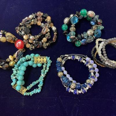 assortment of multi colored beaded bracelets