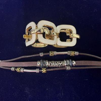 white and gold tone linked bracelet and  leather & beaded bracelet.