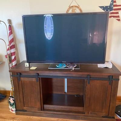 Flat screen looks new and works. The tv cabinet would look great in any home. 