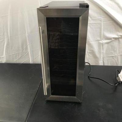 Lot 143 Thermo- Electric Wine Cooler
holds 10  bottles, has temperature control knob and light Measures: 10 1/4