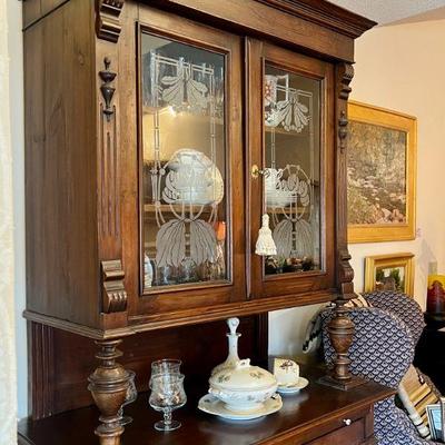 Tall antique buffet cabinet with etched glass inserts