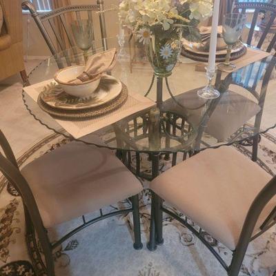 Glass top table and four chairs, top has scalloped edge
