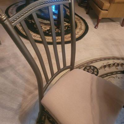 One of the four chairs that go with the glass top table