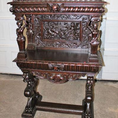 Lot 102: Antique highly carved and ornate mahogany server in the manner of RJ Horner approx. 40