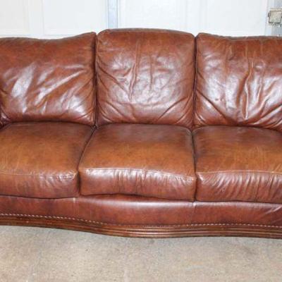 130: Nice leather 3 cushion sofa with carved mahogany arms and tacking approx. 87