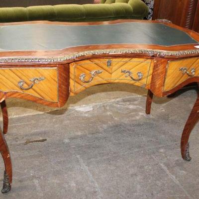 260: Semi antique French style leather top desk with applied bronze, has some veneer loss approx. 52" w x 22" d x 32" h