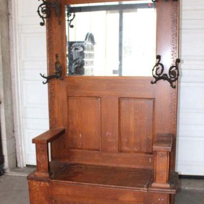 298: Antique carved oak lift top hall rack with fancy hooks, 1 hook is broken approx. 43" w x 19" d x 84" h