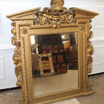 214: Antique highly carved mantle mirror with Victorian head and cherubs, top has been repaired years ago approx. 44" w x 6" d...