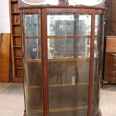 149: Antique quartersawn oak curve glass china cabinet with fancy mirror back shelf top in original finish approx. 41