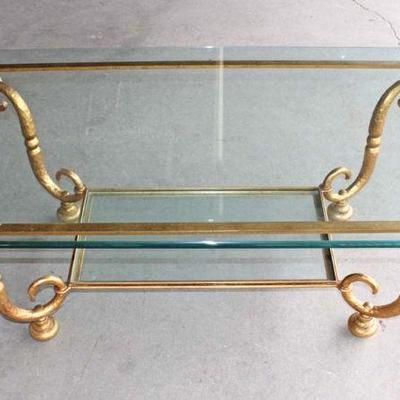 168: Italian design iron base in the gold tone glass top coffee table approx. 53