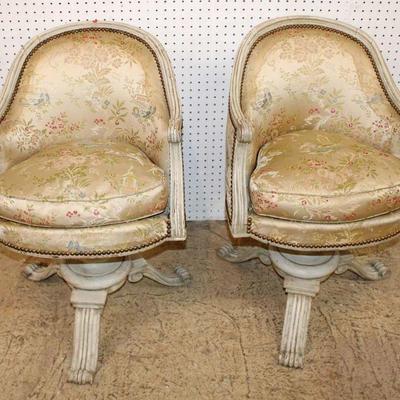 320: Pair of semi antique tacked upholstered swivel occasional chairs in the distressed white finish approx. 22" w x 20" d x...