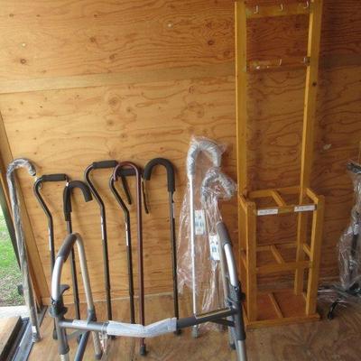 NICE ASSORTMENT OF WALKING CANES, WOODEN DISPLAY RACK AND A HEAVY DUTY WALKER