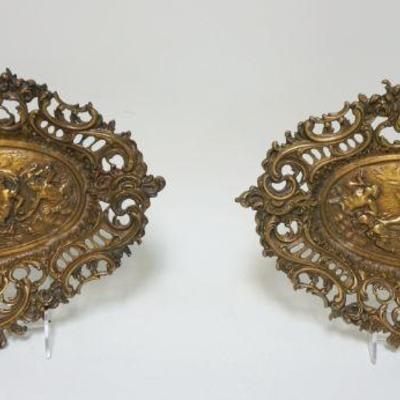 1063	PAIR OF ORNATE OVAL BRASS FOOTED TRAYS W/NEOCLASSICAL SCENES, APPROXIMATELY 13 1/2 IN X 9 IN
