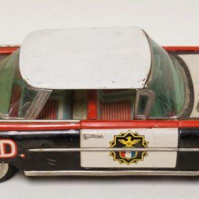 1143	ANTIQUE BATTERY OPERATED TIN TOY HIGHWAY PATROL CAR, MISSING SEARCH LIGHT, APPROXIMATELY 5 IN X 13 IN X 4 IN HIGH
