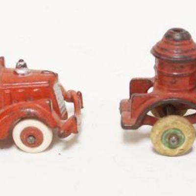 1180	2 ANTIQUE CAST IRON TOY FIRE TRUCKS, ONE HUBLEY, LARGEST APPROXIMATELY 5 IN X 2 IN
