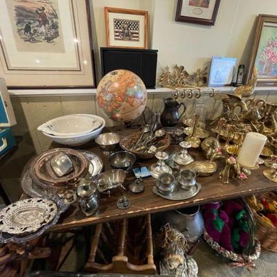 A vast collection of silver cutlery, platters, bowls, vases; and a variety of brass animals, candle holders, etc. 