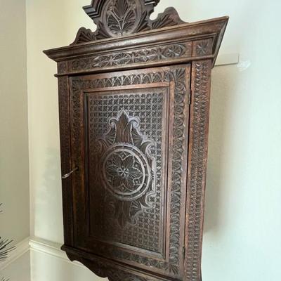 Hand carved cabinet with etching on inner door