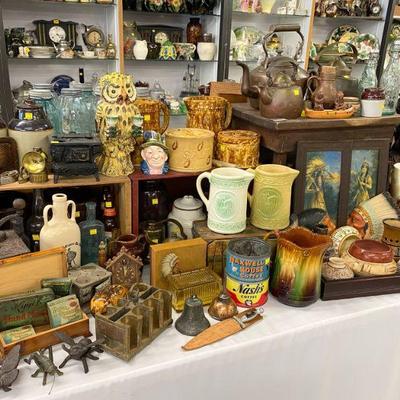 Stoneware milk pitchers, Bennington pottery, antique tins/bottles. 
