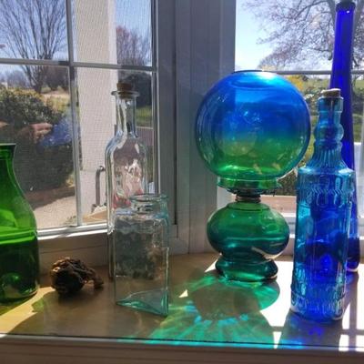 Colored glass bottles and oil lamp