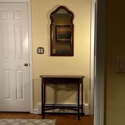 (2pc) Entryway Set | Comprising a small side table with open work apron, and a similar mirror (h. 35 in.)
Dimensions: l. 33 x w. 10 x h....