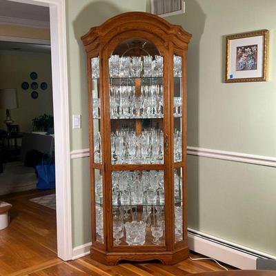Glass Corner Display Cabinet |   Oak with etched glass door, mirrored interior with glass shelves
Dimensions: l. 27 x w. 35 x h. 78 in 