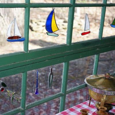 This sale has a large collection of hand crafted and stain glass mobiles, stain glass sail ships, sea glass etc