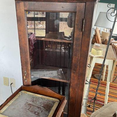 tall oak antique cabinet with glass door.
