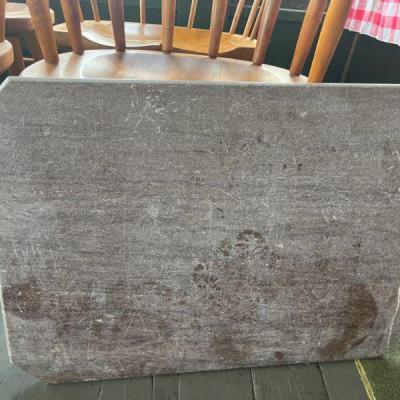 This is an antique piece of red marble that needs restoration . For a parlor table