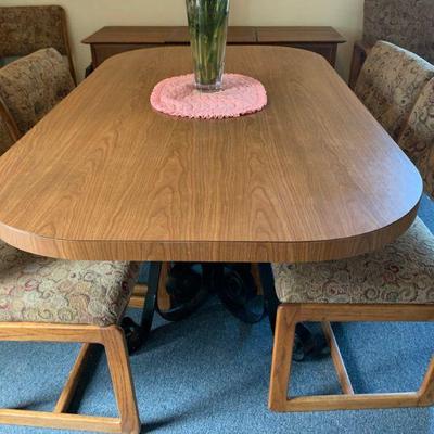 Formica dinette table with 7 upholstered chairs.