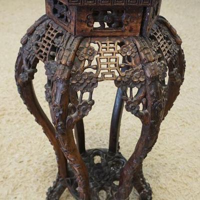 1082	ORNATE CARVED FRETWORK ASIAN STAND	ORNATE CARVED FRETWORK ASIAN STAND, APPROXIMATELY 15 IN WIDE X 17 IN DEEP X 32 IN HIGH
