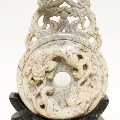 1045	INTRICATE CARVED ASIAN STONE IN CARVED STONE BASE	INTRICATE CARVED ASIAN STONE IN CARVED STONE BASE, APPROXIMATELY 10 IN HIGH
