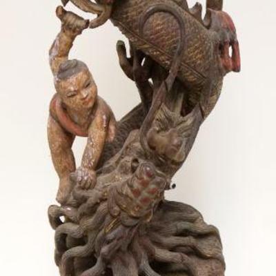 1004	CARVED WOOD ASIAN SERPENT W/PEOPLE	CARVED WOOD ASIAN SERPENT SURROUNDED BY PEOPLE, APPROXIMATELY 21 IN HIGH
