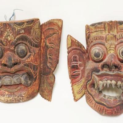 1002	2 CARVED WOOD PAINT DECORATED ASIAN MASKS	2 CARVED WOOD PAINT DECORATED ASIAN MASKS, LARGEST APPROXIMATELY 11 IN X 1 1/2 IN
