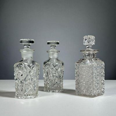 (3PC) CUT GLASS PERFUME BOTTLES | Including a pair of round bottles and a single bottle, each with a stopper
Dimensions: w. 2-1/2 x h....