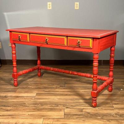 RED PAINTED WRITING DESK | By Stanley Furniture, desk / writing table having three drawers over turned legs. Dimensions: l. 49 x w. 23 in 