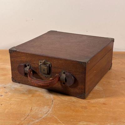 ANTIQUE WOODEN CASE | With brass corners and latch and a leather carrying handle
Dimensions: 5 x 11 x 11 in. 