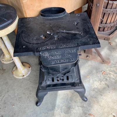 Antique stove used in laundry to heat sad irons.