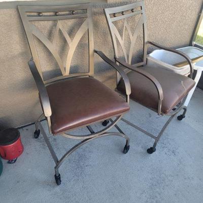 Two of the chairs that go with the patio table set