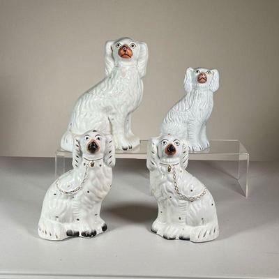 (4PC) CERAMIC STAFFORDSHIRE DOGS | Four classic white ceramic Staffordshire dogs of tapering size with painted collar and leash. h. 10 in...