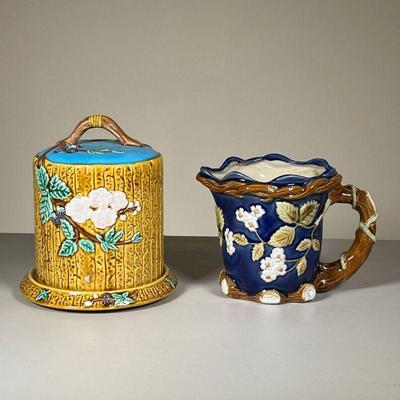 (2PC) CERAMICS | Including a Majolica cheese keeper by Seymour Mann and a Majolica pitcher with flowers and leaves. h. 8 in (tallest)  