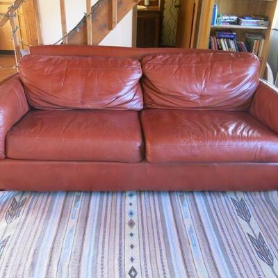 Red Leather Couch by Latitudes