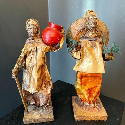 Lot 006-DR: Paper Mache Figures

Features: 
â€¢	Both figures appear to be women in rustic, ethnic garb. Each is affixed to a 4â€ wooden...