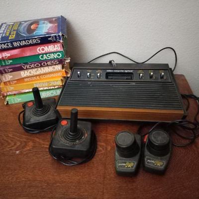 Vintage Atari 7600 system with pong paddles, joysticks, and games 