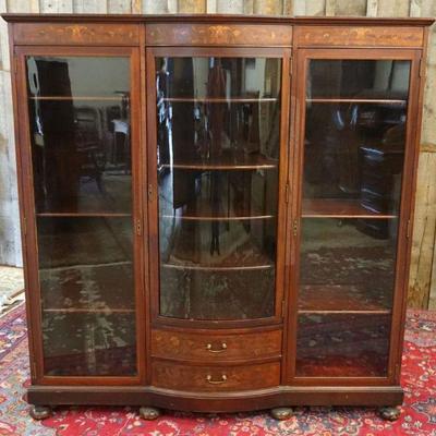 1086	MAHOGANY TRIPLE DOOR 2 DRAWER INLAID BOOKCASE, CENTER GLASS DOOR HAS BOW FRONT, ALL SHELVES ADJUSTABLE, APPROXIMATELY 63 IN X 18 IN...