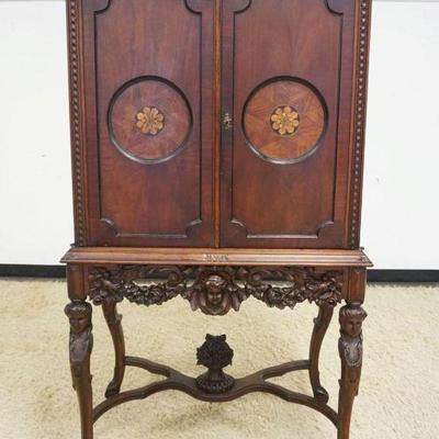 1113	OUTSTANDING WALNUT CARVED 2 DOOR CABINET, DOORS HAS 2 ROUND INLAID PANELS, INTERIOR W/3 SHELVES & ONE DRAWER, BASE HAS CARVING OF...