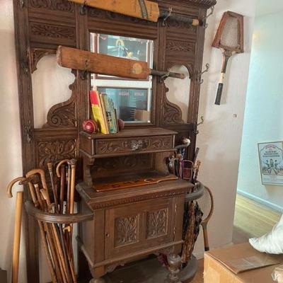 A beautiful antique hall tree! All original hardware! (picture are antique cricket bats, tennis rackets, umbrellas, riding crops & misc....