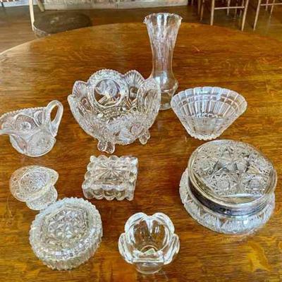 Lot 061-LR: Clear Glass

Features: 
â€¢	Nine pieces
â€¢	Large footed bowl is cut glass

Dimensions: Powder dish â€“ 7â€D (at base) x...