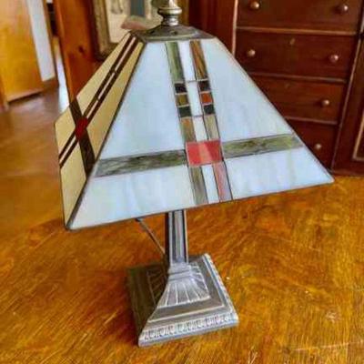 Lot 105-BR1: Mission-Style Lamp

Features: 
â€¢	Electric Mission style lamp
â€¢	Colors on shade feature green, red and orange hues...